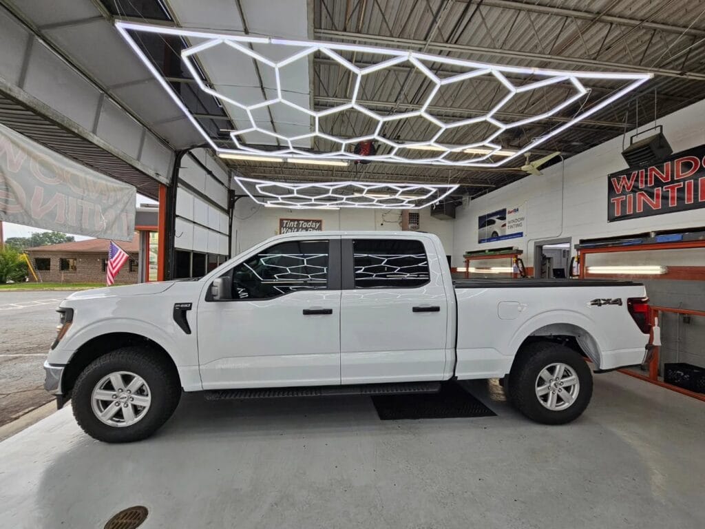 White van with tinted windows inside of The Tint Shop Plus